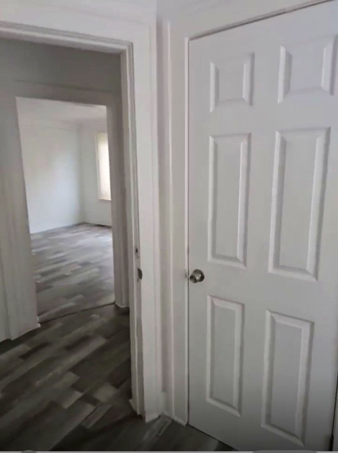 Hallway looking into bright bedroom